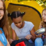 overweight, obese, obesity, Cute beautiful girl sitting near yellow tent with her friends during sunny autumn day at campsite
